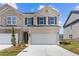 Charming brick townhome with a two-car garage and well-maintained landscaping at 847 Pensive Run, Dacula, GA 30019
