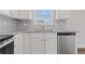 Granite countertops and stainless steel dishwasher in bright modern kitchen at 847 Pensive Run, Dacula, GA 30019