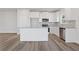 Modern kitchen with white cabinets, stainless steel appliances, and a central island at 847 Pensive Run, Dacula, GA 30019