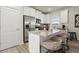 Well-equipped kitchen boasting white cabinetry, granite countertops, stainless steel appliances, and an island at 847 Pensive Run, Dacula, GA 30019