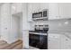 Kitchen with stainless steel appliances and white cabinets at 847 Pensive Run, Dacula, GA 30019