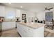 Spacious kitchen featuring granite countertops, stainless appliances, a central island, and open living concept at 847 Pensive Run, Dacula, GA 30019