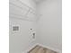 Compact laundry area with a wire shelf, ready for washer and dryer hookups at 847 Pensive Run, Dacula, GA 30019