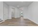 Living room features wood-look flooring, high ceilings, and a view of the front door at 847 Pensive Run, Dacula, GA 30019