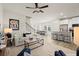 Bright, open-concept living room with modern furnishings and a stylish ceiling fan at 847 Pensive Run, Dacula, GA 30019