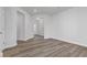 A cozy living room with wood flooring, featuring an open entryway and ample lighting at 847 Pensive Run, Dacula, GA 30019