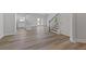 Spacious living room featuring wood floors, white walls, and ample natural light at 847 Pensive Run, Dacula, GA 30019