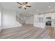 Open-concept living space with kitchen, featuring stainless steel appliances and modern light wood-look floors at 847 Pensive Run, Dacula, GA 30019