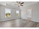 Bright, spacious main bedroom boasts tray ceiling and wood-look floors with ensuite bath access at 847 Pensive Run, Dacula, GA 30019