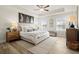Serene bedroom with tray ceiling, ceiling fan, and ample natural light from multiple windows at 847 Pensive Run, Dacula, GA 30019