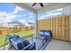 Enjoy outdoor living on this covered patio with comfortable seating and a view of the backyard at 847 Pensive Run, Dacula, GA 30019