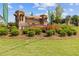 The Alcovey Meadows entrance sign is surrounded by colorful flowers and lush greenery at 847 Pensive Run, Dacula, GA 30019
