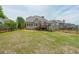 Large backyard featuring a well-maintained lawn, a wooden deck, and a red fence at 31 Vine Creek Ln, Acworth, GA 30101