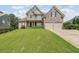 Charming two-story home with stone accents, a well-manicured lawn, and a welcoming front porch at 31 Vine Creek Ln, Acworth, GA 30101