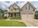 Charming two-story stone home featuring a well-manicured lawn and a two-car garage at 31 Vine Creek Ln, Acworth, GA 30101