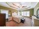 A relaxing main bedroom featuring a trey ceiling, a fan, and neutral carpet at 31 Vine Creek Ln, Acworth, GA 30101