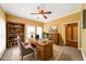 Cozy home office with a wooden desk, bookshelves, and natural light from the windows at 31 Vine Creek Ln, Acworth, GA 30101