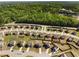 An aerial view of a housing community with mature trees and newly built houses at 336 Elaina Cir, Locust Grove, GA 30248