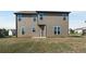 Exterior shot of the backyard with an outdoor patio and fresh green grass at 336 Elaina Cir, Locust Grove, GA 30248