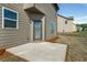 Backyard view with a concrete patio, gray siding, and manicured lawn at 336 Elaina Cir, Locust Grove, GA 30248