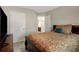 Bedroom with a wooden sleigh bed, matching dresser, carpeted flooring, and door at 336 Elaina Cir, Locust Grove, GA 30248