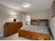 Bedroom with a wooden sleigh bed, matching dresser, carpeted flooring, and natural light at 336 Elaina Cir, Locust Grove, GA 30248