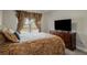 Bedroom with a wooden sleigh bed, matching dresser, carpeted flooring, TV and natural light at 336 Elaina Cir, Locust Grove, GA 30248