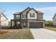 Charming two-story home with brick and siding, a well-manicured lawn, and an attached two-car garage at 336 Elaina Cir, Locust Grove, GA 30248