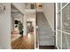 Welcoming foyer with staircase, wood flooring, and views into the living spaces beyond at 336 Elaina Cir, Locust Grove, GA 30248