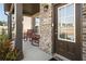 Inviting front porch featuring brick accents, rocking chairs, and a stylish front door with glass panels at 336 Elaina Cir, Locust Grove, GA 30248