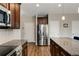 Spacious kitchen with stainless steel refrigerator, dark wood cabinets, granite countertops, and a functional center island at 336 Elaina Cir, Locust Grove, GA 30248