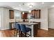 Modern kitchen with dark wood cabinets, stainless steel appliances, granite countertops, and a center island with seating at 336 Elaina Cir, Locust Grove, GA 30248