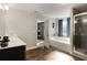 Main bathroom featuring a soaking tub, glass-enclosed shower, dual vanity, and wood-look flooring at 336 Elaina Cir, Locust Grove, GA 30248