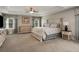 Spacious main bedroom featuring a tray ceiling, plush carpeting, neutral decor, and elegant furnishings at 336 Elaina Cir, Locust Grove, GA 30248