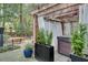 Secluded backyard with a pergola-covered hot tub and dining area, perfect for entertaining at 703 Cumberland Ne Cir, Atlanta, GA 30306