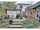 Charming backyard patio featuring a pergola, dining set, and lush landscaping at 703 Cumberland Ne Cir, Atlanta, GA 30306