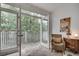 Cozy sitting area with wicker chair provides access to a private balcony overlooking lush greenery at 703 Cumberland Ne Cir, Atlanta, GA 30306