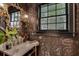 Chic half-bath with dark floral wallpaper, vanity and modern lighting at 703 Cumberland Ne Cir, Atlanta, GA 30306