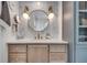 Elegant bathroom vanity with stylish round mirror and modern sconces at 703 Cumberland Ne Cir, Atlanta, GA 30306