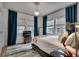 Bright bedroom with large windows, neutral decor and hardwood floors at 703 Cumberland Ne Cir, Atlanta, GA 30306