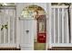 Charming courtyard with brick walls, pergola, chandelier, and vintage Coca-Cola cooler visible through arched gate at 703 Cumberland Ne Cir, Atlanta, GA 30306