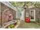 Charming courtyard with brick walls, fountain, pergola, chandelier, and vintage Coca-Cola cooler at 703 Cumberland Ne Cir, Atlanta, GA 30306
