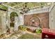 Charming courtyard with brick walls, fountain, pergola, chandelier, and vintage Coca-Cola cooler at 703 Cumberland Ne Cir, Atlanta, GA 30306