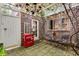 Enchanting courtyard with brick walls, pergola, chandelier, seating area, and vintage Coca-Cola cooler at 703 Cumberland Ne Cir, Atlanta, GA 30306