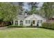 Charming white brick home with manicured lawn and lush landscaping, showcasing classic curb appeal at 703 Cumberland Ne Cir, Atlanta, GA 30306
