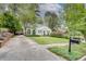 Charming home with a well-manicured front yard, brick driveway, and inviting curb appeal at 703 Cumberland Ne Cir, Atlanta, GA 30306