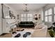 Stylish living room with piano, plush seating, chandelier, and bright ambiance at 703 Cumberland Ne Cir, Atlanta, GA 30306
