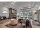 Spacious living room featuring a stone fireplace, tray ceiling, and multiple arched windows at 703 Cumberland Ne Cir, Atlanta, GA 30306