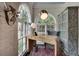 Cozy office with unique desk, patterned rug, large arched window and stylish decor at 703 Cumberland Ne Cir, Atlanta, GA 30306