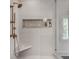Modern shower with marble bench, rainfall shower head, and built-in niche at 703 Cumberland Ne Cir, Atlanta, GA 30306